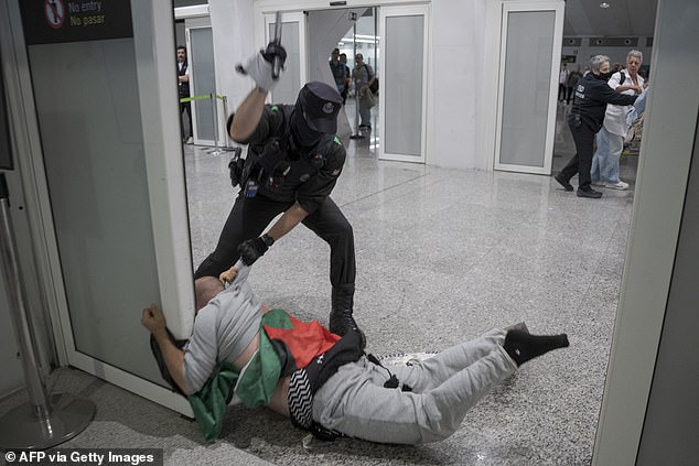 Basque police beat activists returning from Israel in chaotic Bilbao airport clash