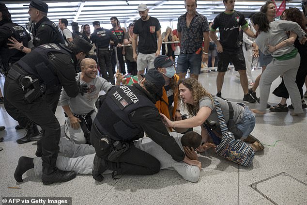 Basque police beat activists returning from Israel in chaotic Bilbao airport clash