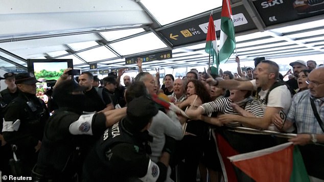 Basque police beat activists returning from Israel in chaotic Bilbao airport clash